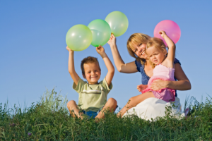 mother and children holding balloons